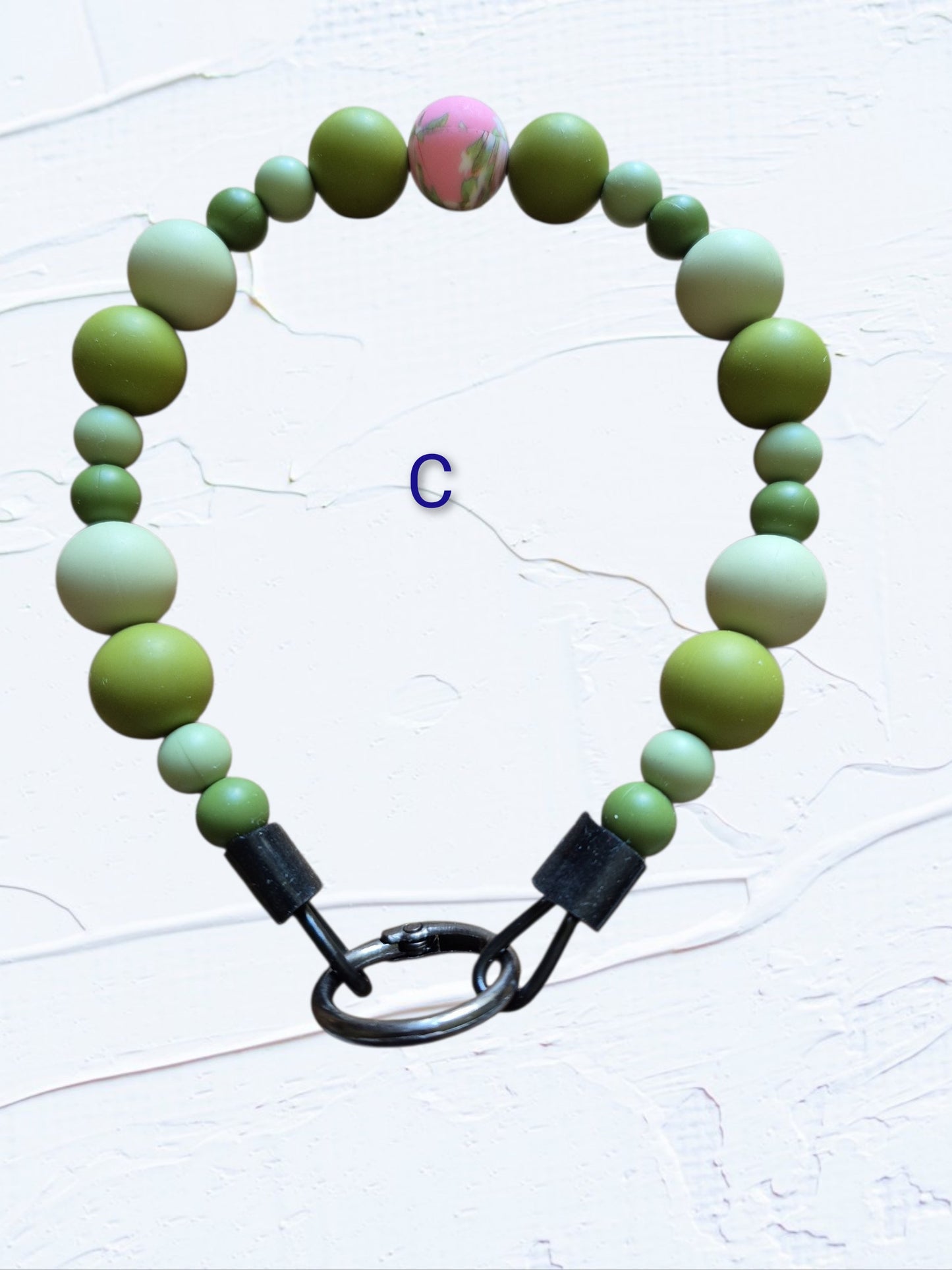 olive and sage green beads with a pink marbled accent bead