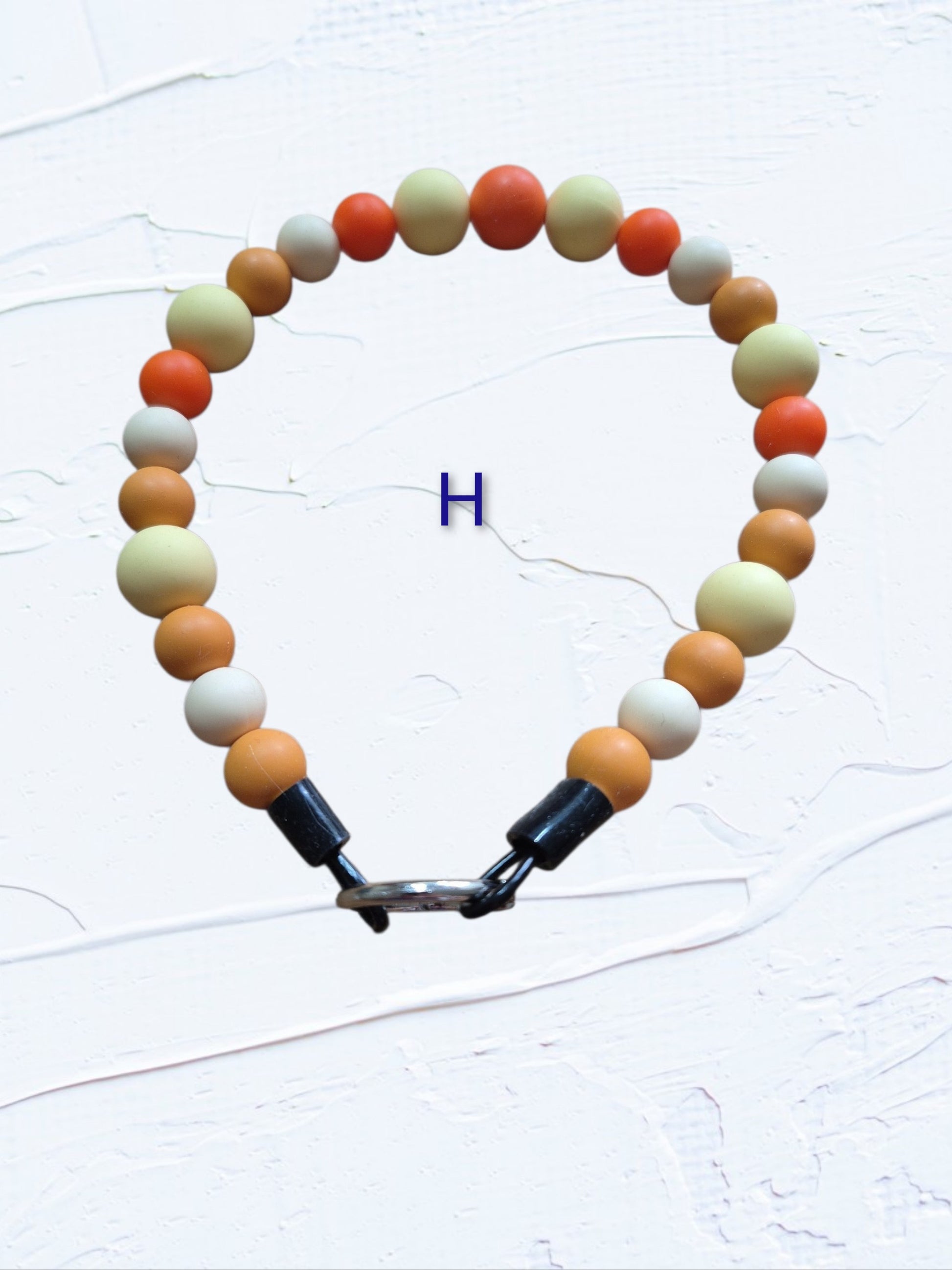 15 inch silicone beaded dog collar Colour H – orange, cream and tan silicone beads with silver O-ring clasp, handmade in Canada
