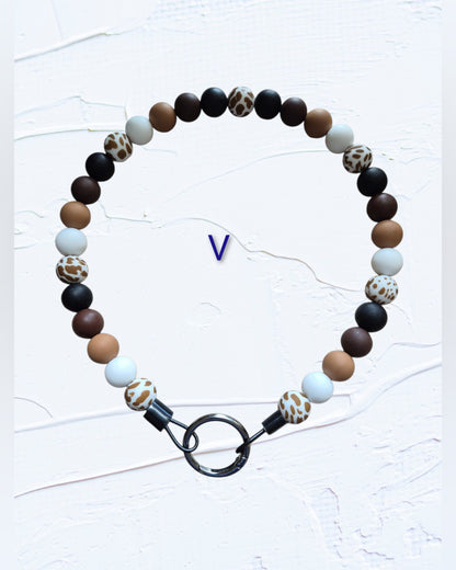 black, brown, tan, white and leopard print accent beads with black O-ring clasp